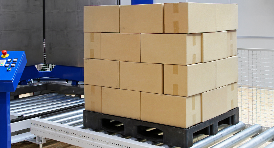 Fóliázásra váró raklapos áru automatikus magasságmérésének folyamata ipari környezetben.